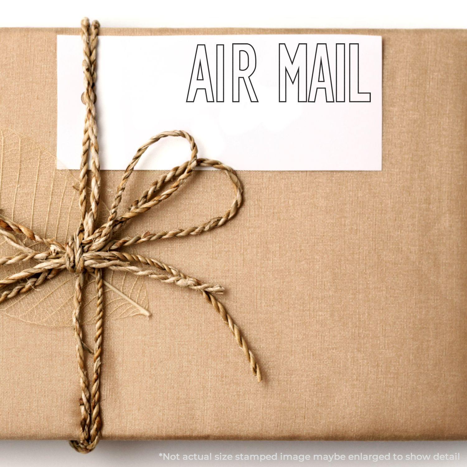 A brown package tied with twine, featuring a white card stamped with AIR MAIL in an outline font.