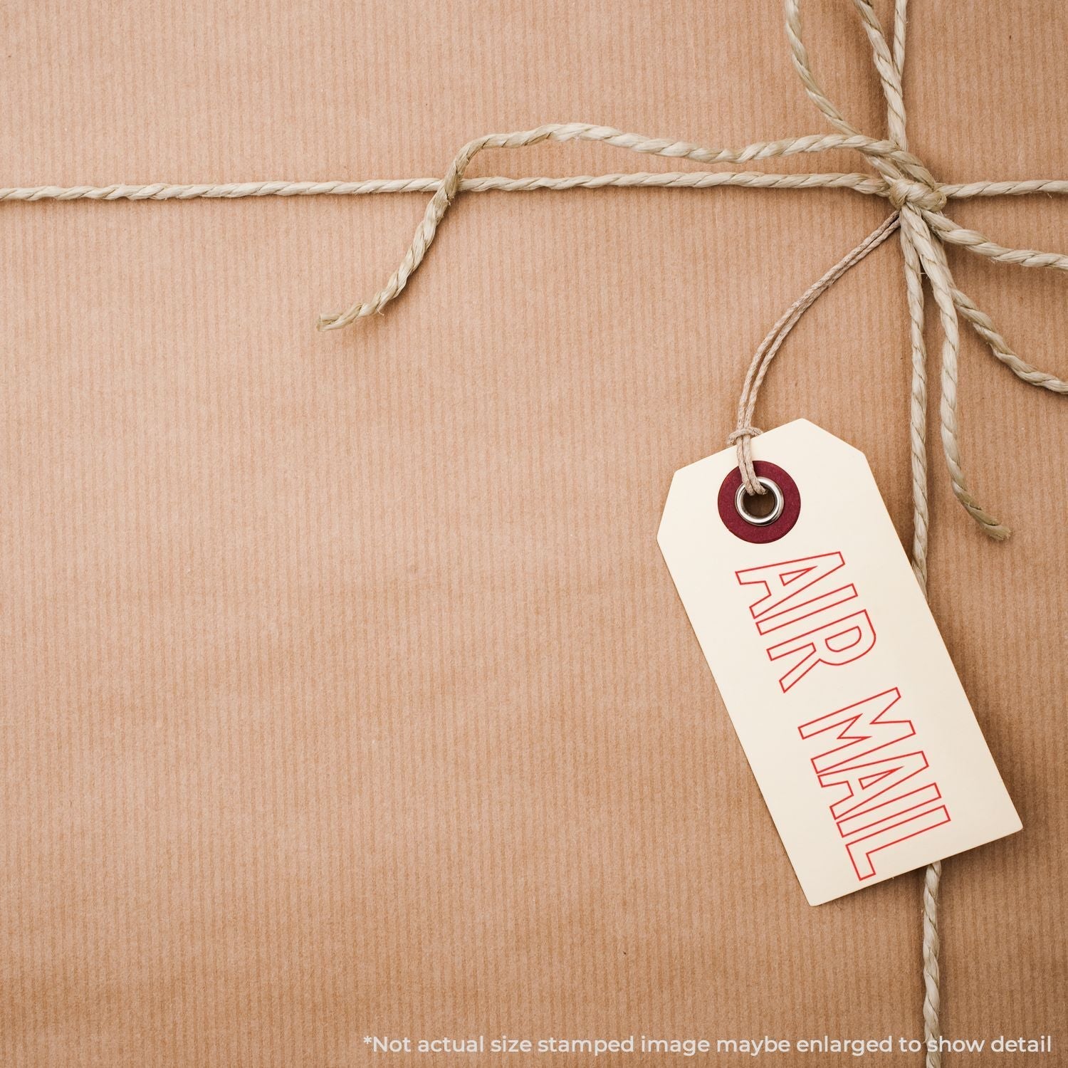 A brown paper package tied with twine, featuring a tag stamped with AIR MAIL using the Self Inking Outline Air Mail Stamp.