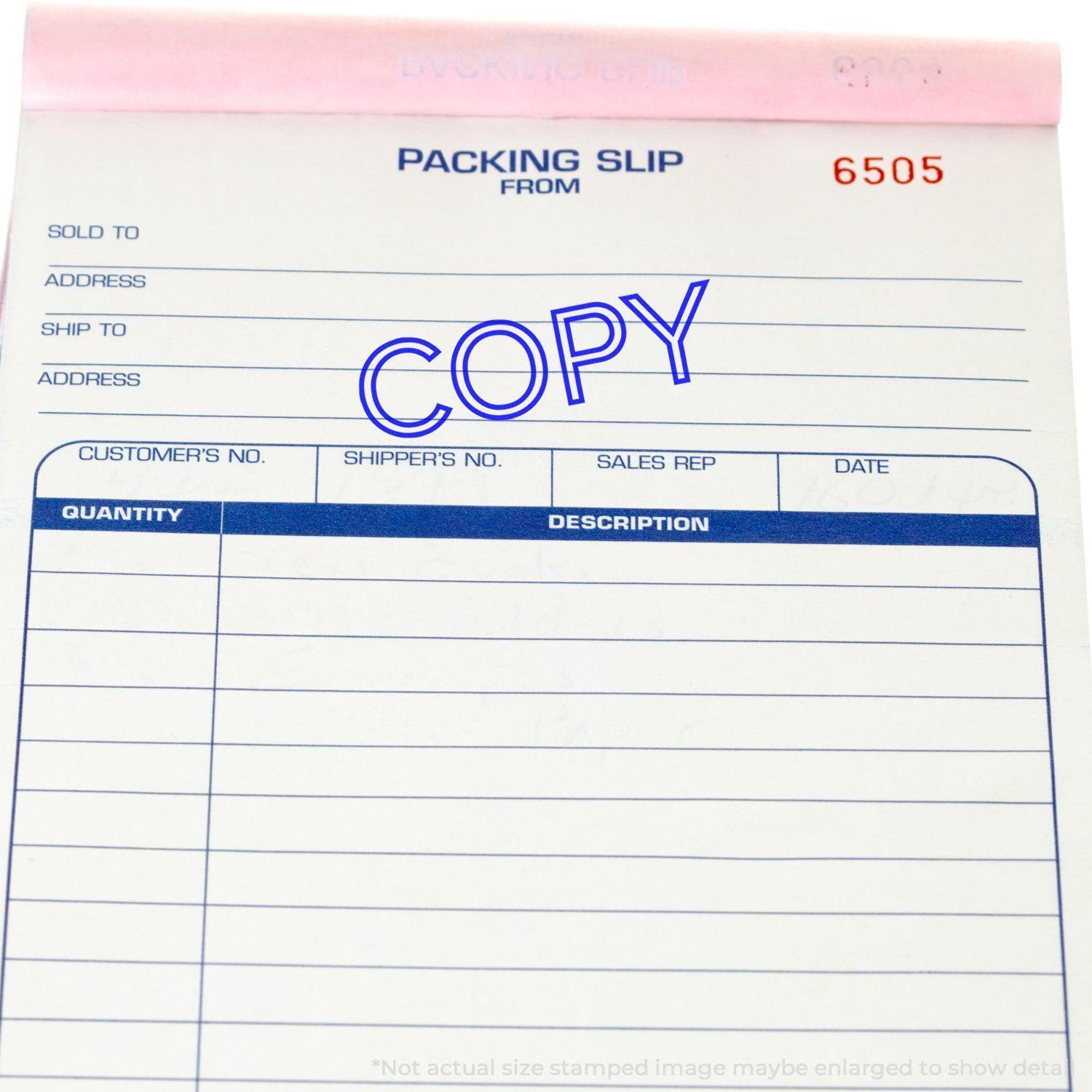 A stock office rubber stamp with a stamped image showing how the text "COPY" in a large outline font is displayed after stamping.