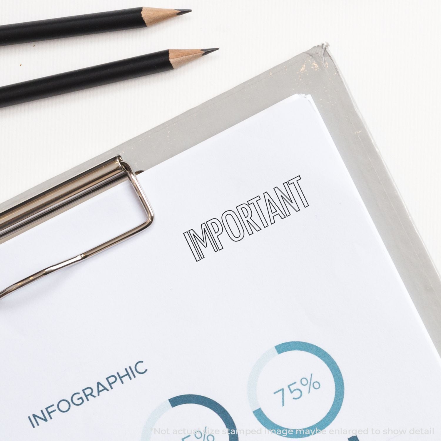 Self Inking Outline Important Stamp marking IMPORTANT on a document with a clipboard and two pencils nearby.