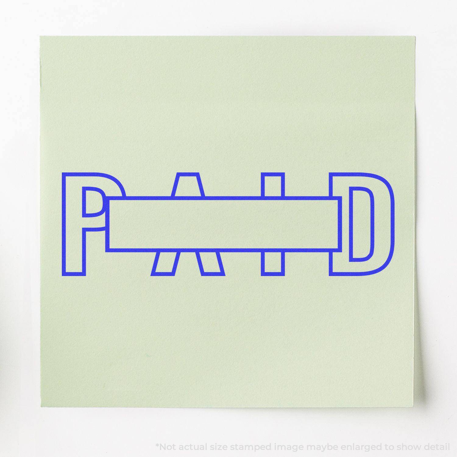 Large Outline Paid with Box Rubber Stamp in blue ink on a light green paper, showing the word PAID with a box in the center.