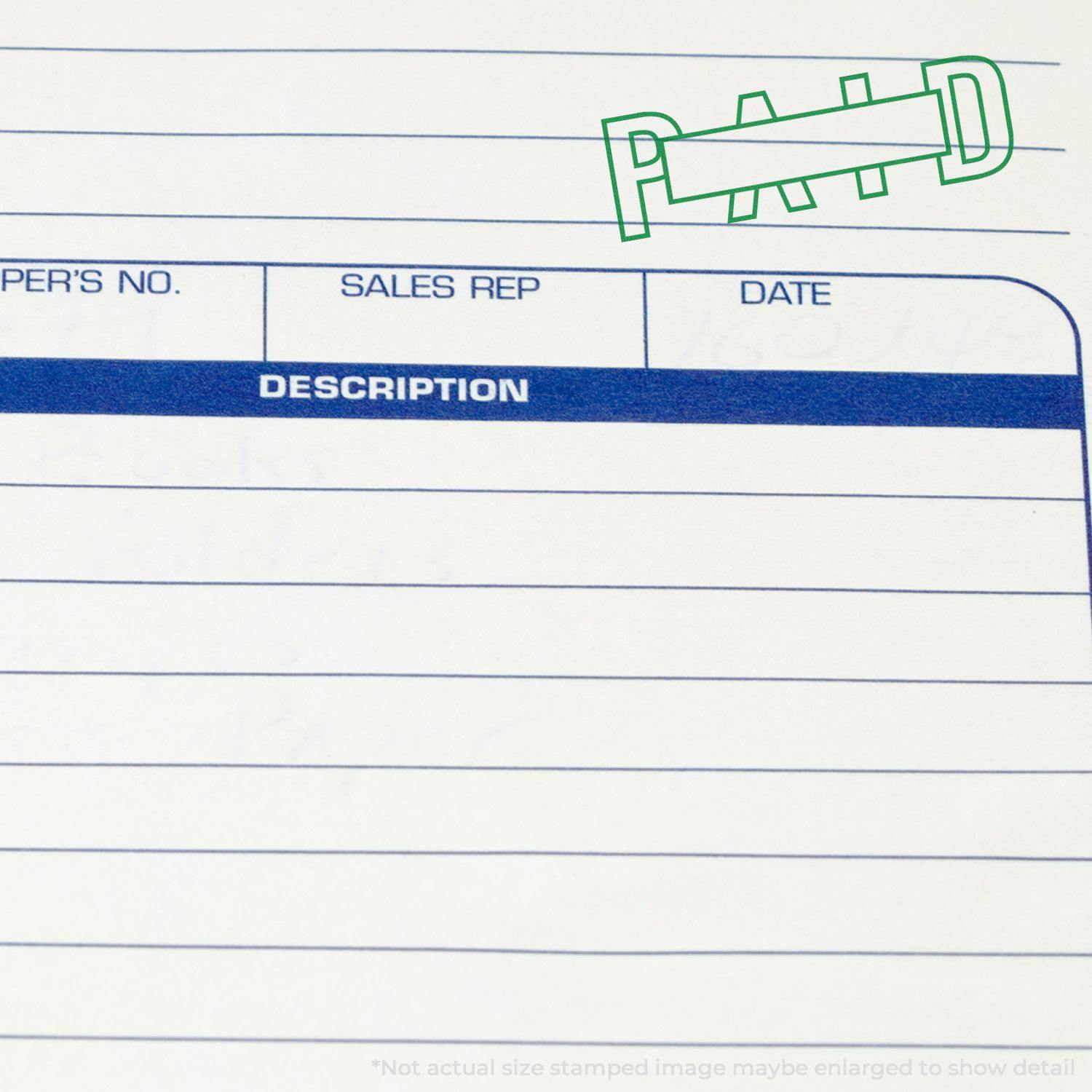 Large Pre-Inked Outline Paid with Box Stamp in green ink on a document with lines for description, sales rep, and date.