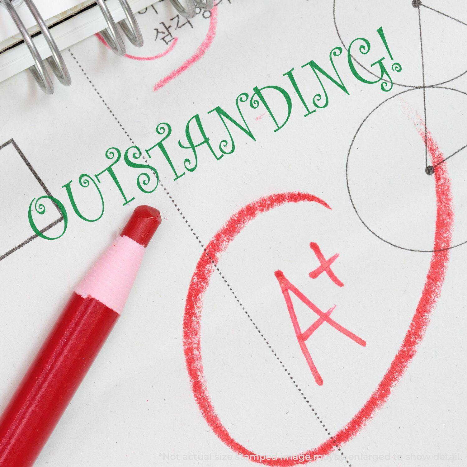 Red pen marking an A+ on paper with OUTSTANDING! stamped using the Large Outstanding Rubber Stamp.