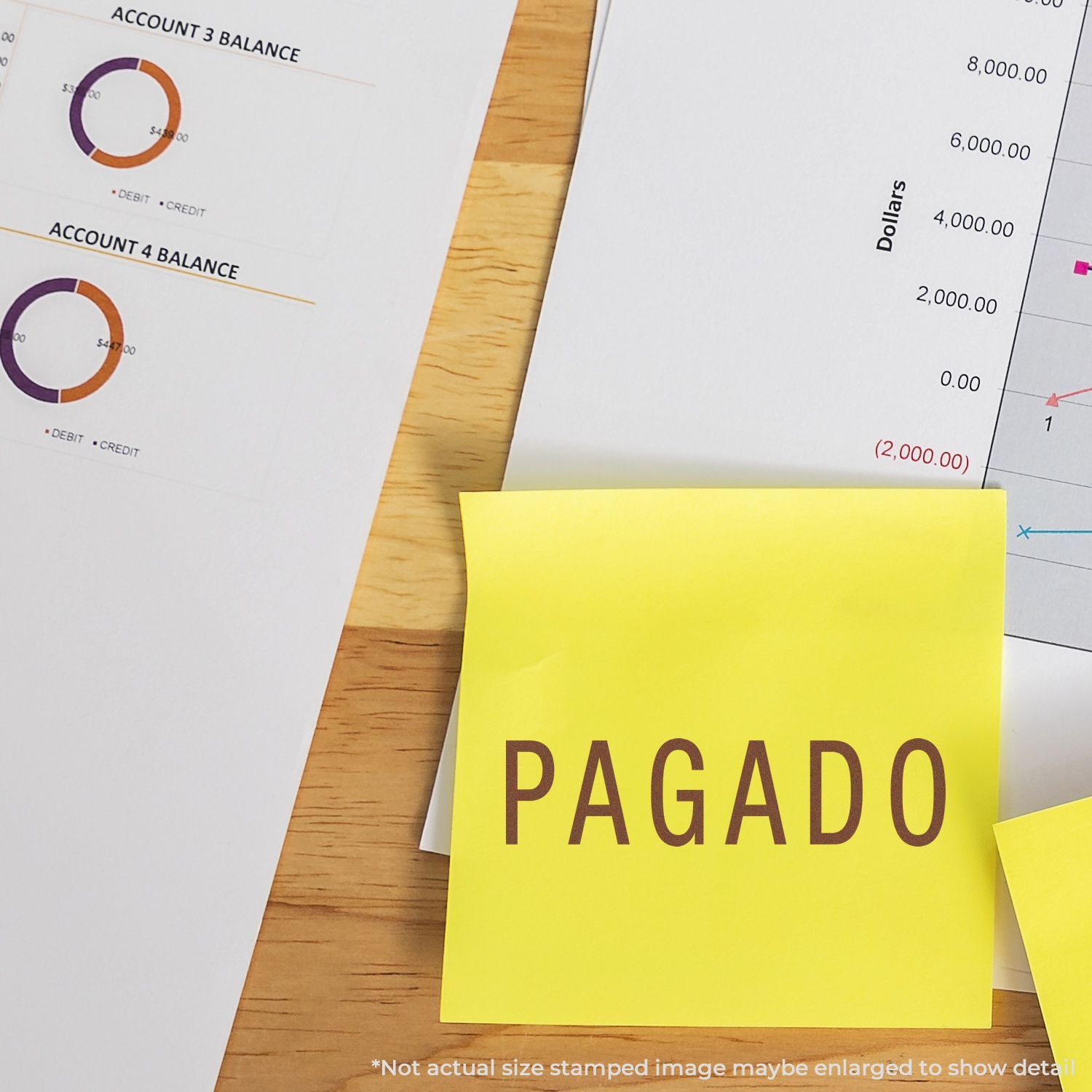 Self Inking Pagado Stamp used on a yellow sticky note, placed on financial documents with charts and graphs.