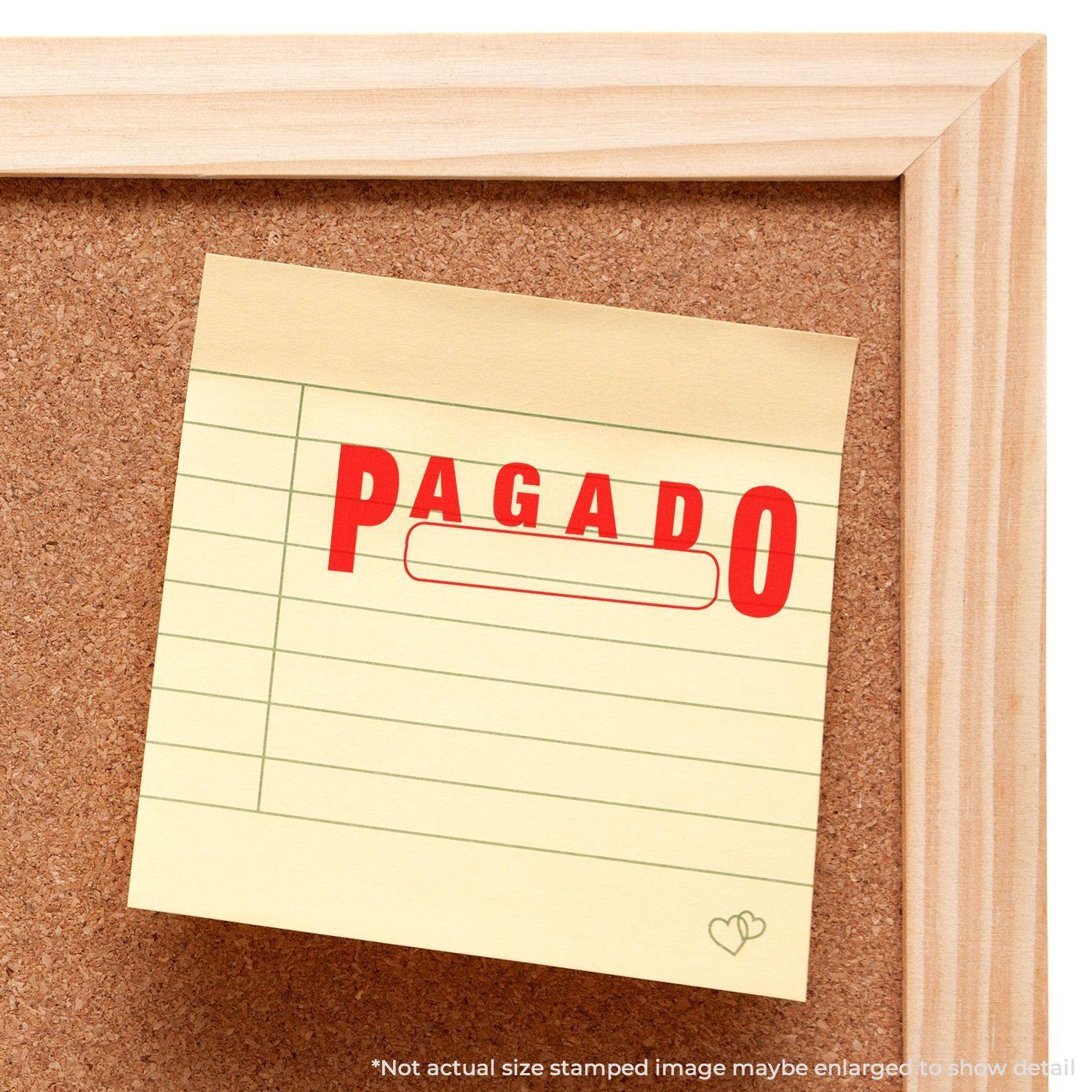 A corkboard with a sticky note stamped PAGADO using the Large Pagado with Box Rubber Stamp. The note has a red stamp with a blank box.