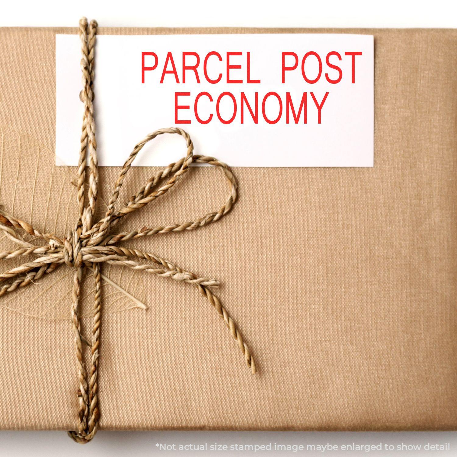 A stock office rubber stamp with a stamped image showing how the text "PARCEL POST ECONOMY" in a large font is displayed after stamping.