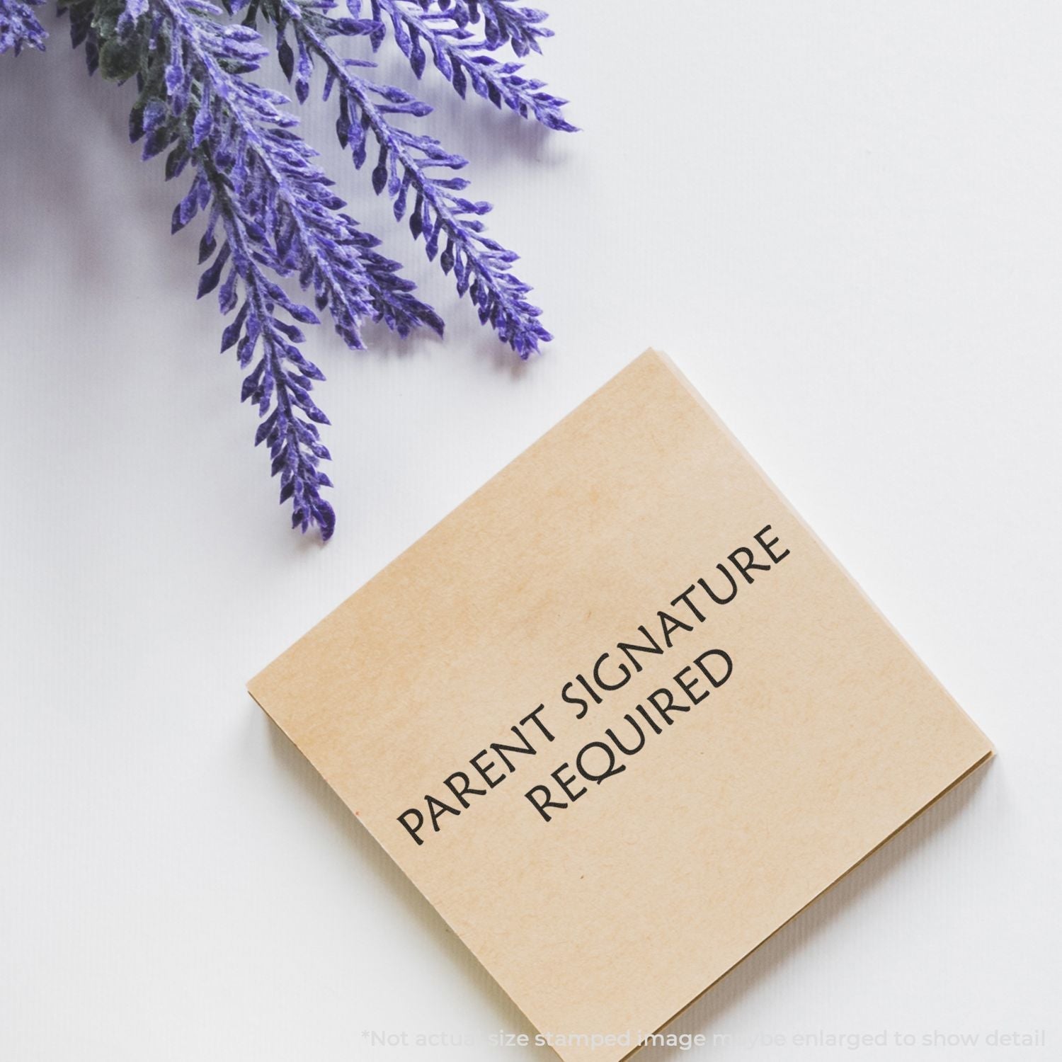 Self Inking Parent Signature Required Stamp on a white surface with lavender flowers in the corner.