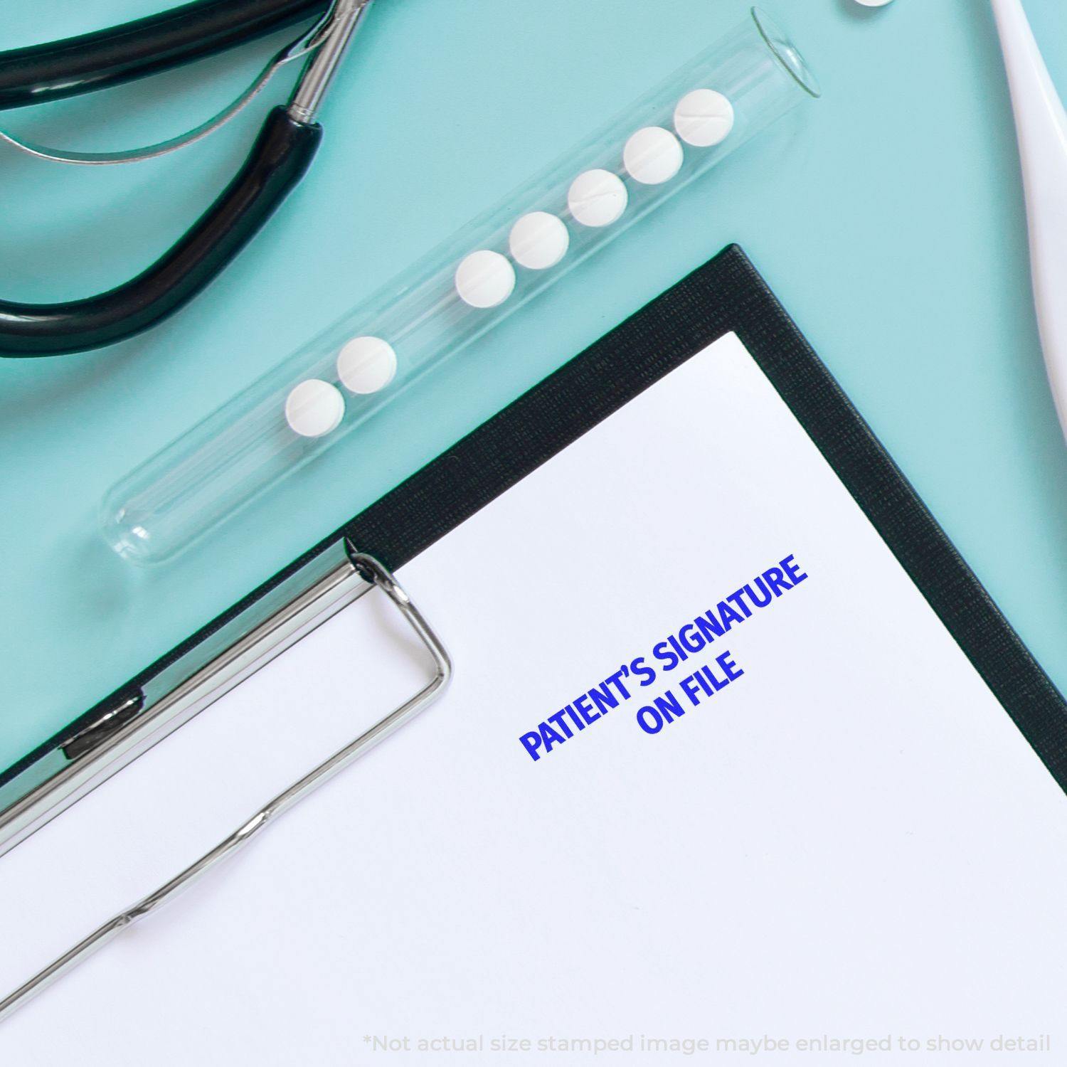 Large Patient's Signature on File Rubber Stamp used on a clipboard, with a stethoscope and test tube nearby on a light blue surface.