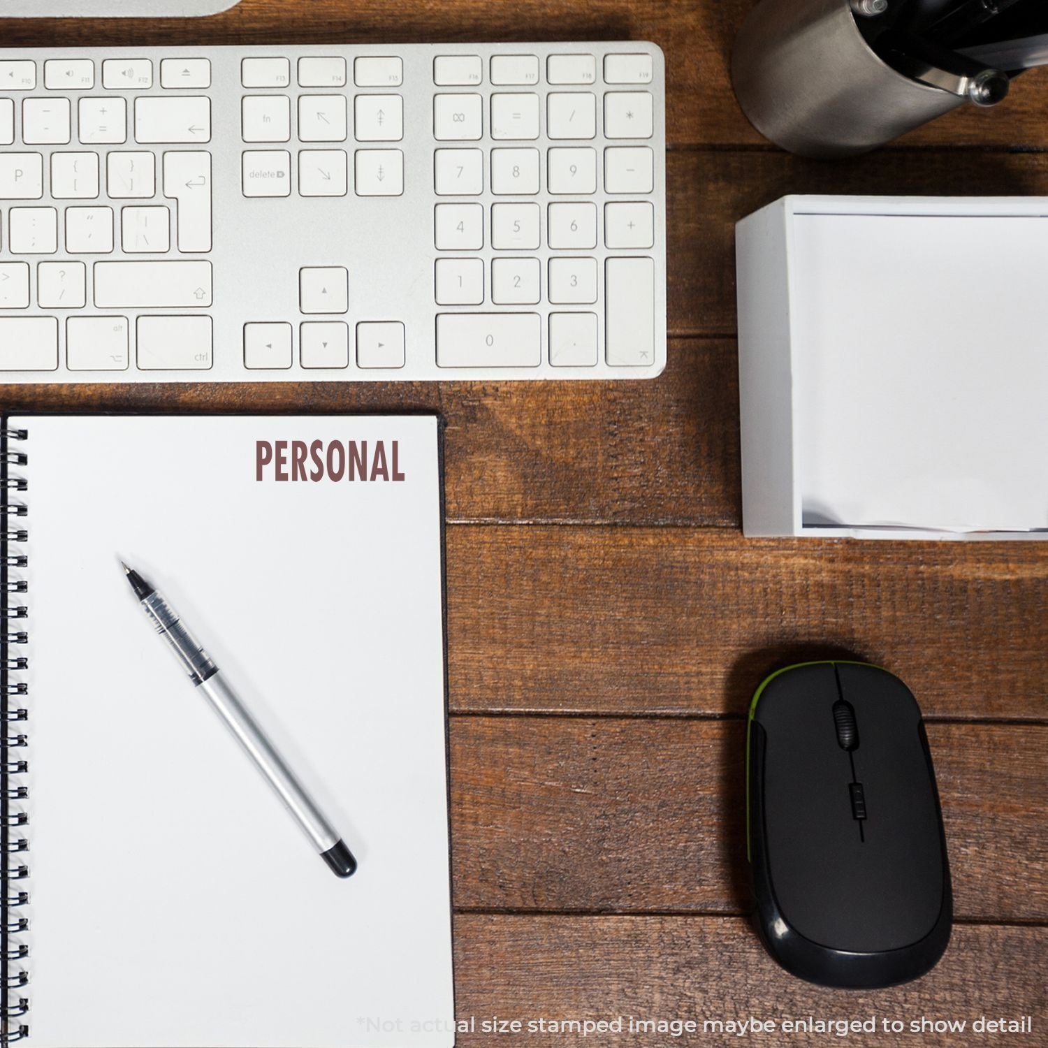 A Self Inking Personal Stamp marks PERSONAL on a notebook page, placed on a wooden desk with a keyboard, mouse, and pen.