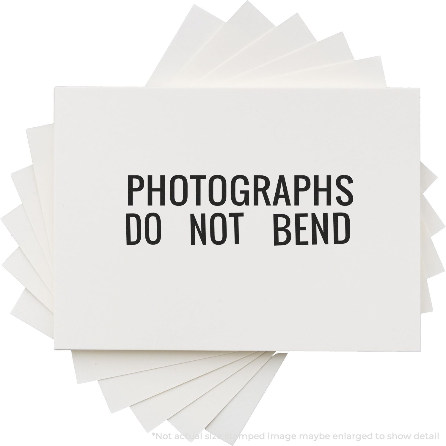 Self Inking Photographs Do Not Bend Stamp used on a stack of white envelopes, clearly marking them to prevent bending.