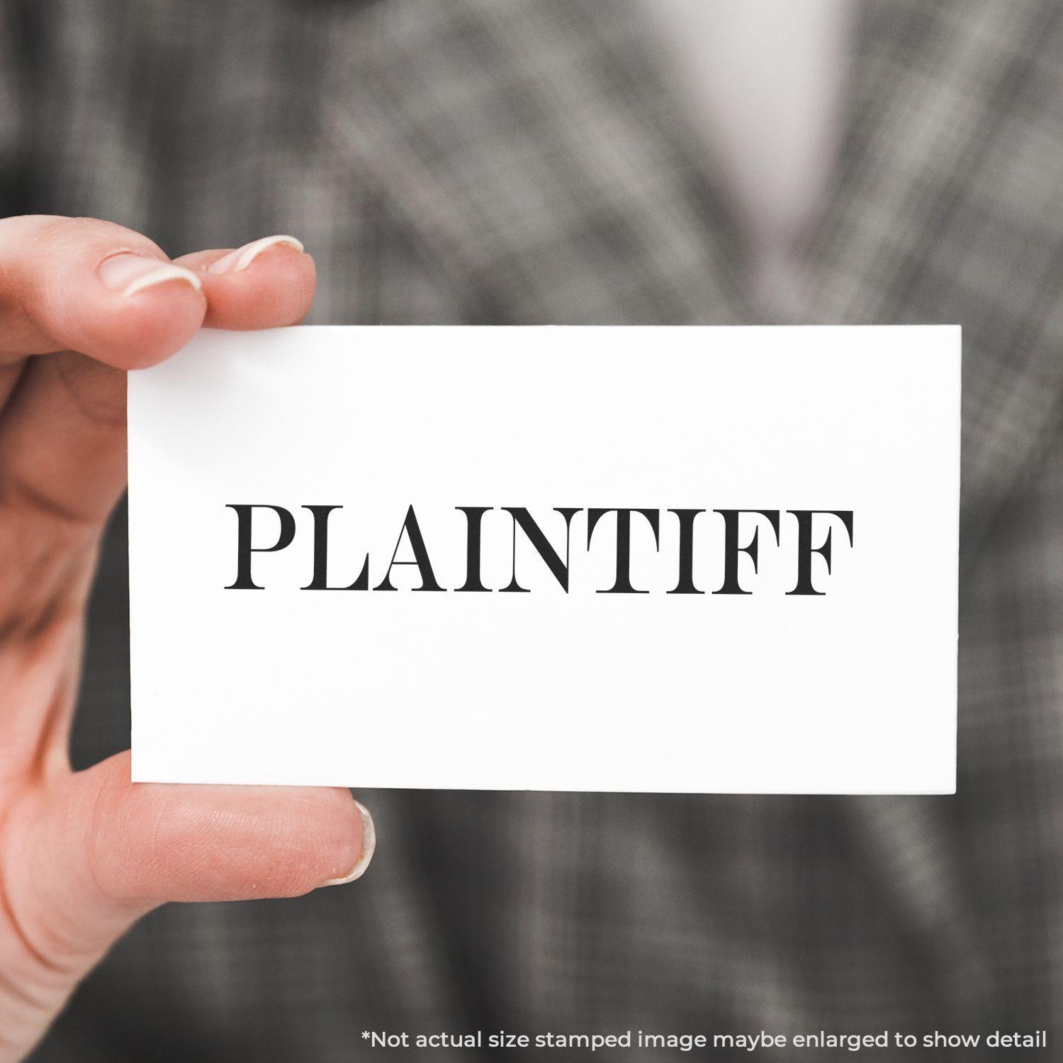 A stock office rubber stamp with a stamped image showing how the text "PLAINTIFF" in a large font is displayed after stamping.