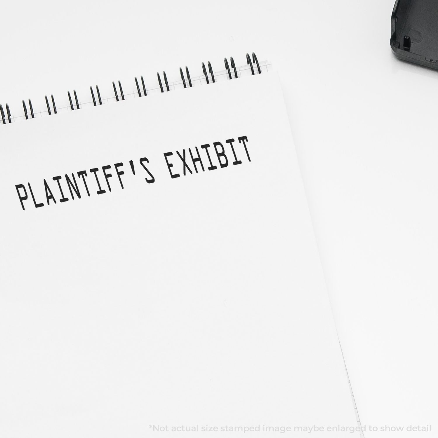 Self Inking Plaintiff's Exhibit Stamp used on a white notepad, displaying the text PLAINTIFF'S EXHIBIT in black ink.