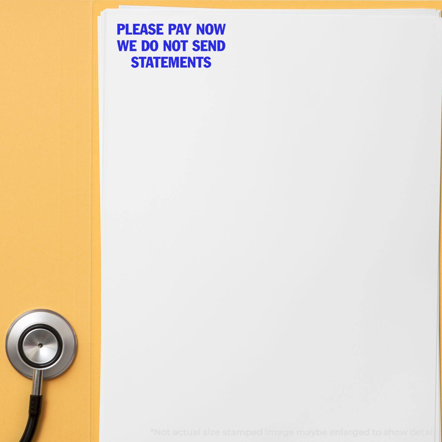 A Large Please Pay Now No Statements Rubber Stamp is used on a white paper, placed on a yellow folder with a stethoscope beside it.