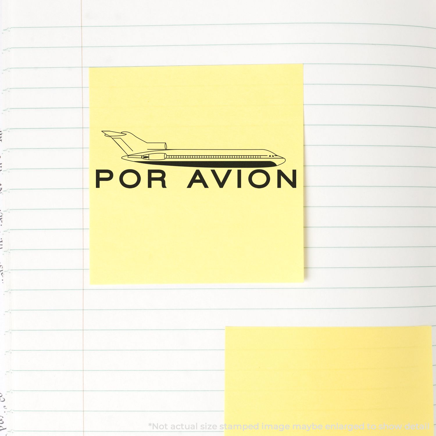 Yellow sticky note with a stamped airplane and text POR AVION using a Self Inking Por Avion Stamp on lined notebook paper.