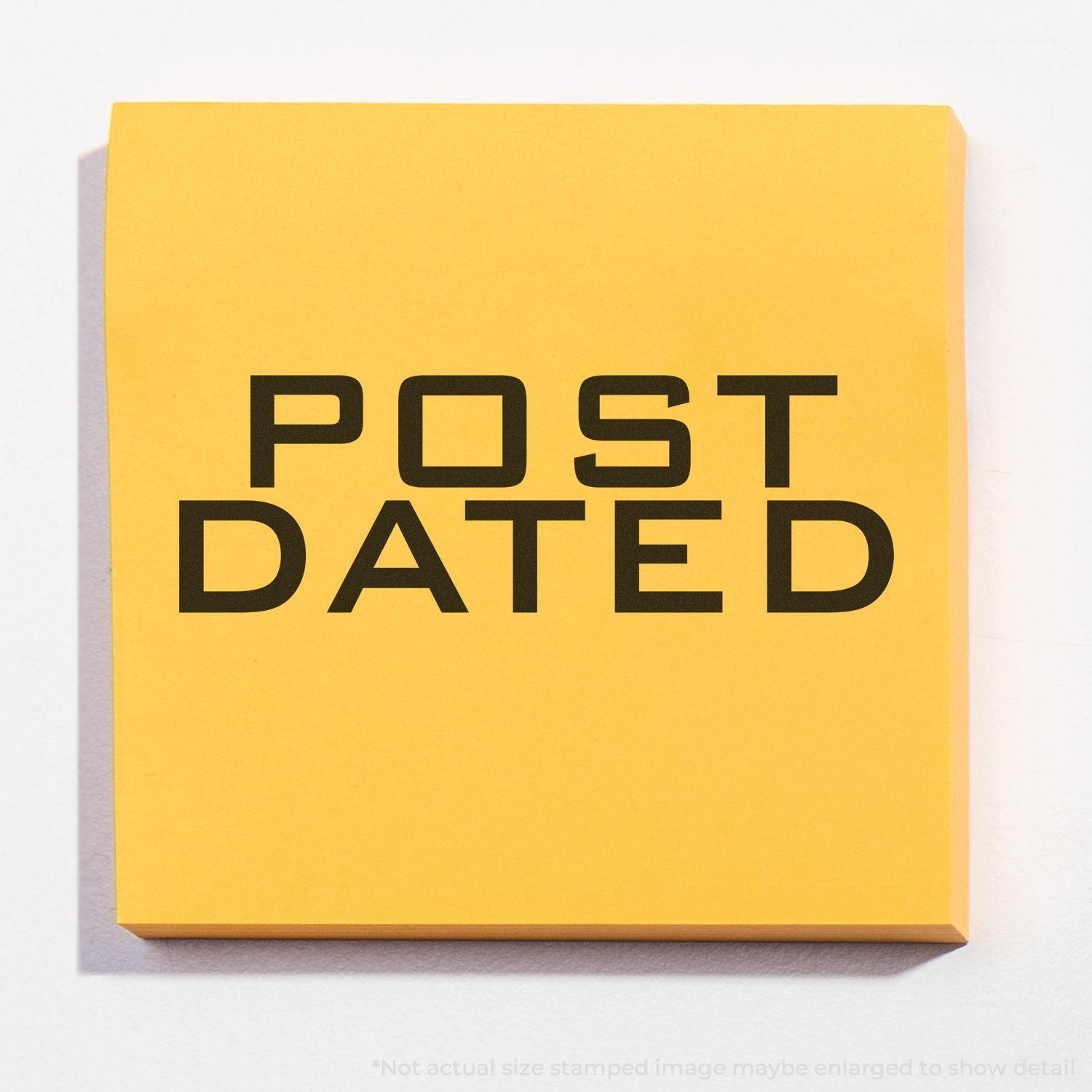 Yellow sticky note with bold black text POST DATED, created using a post dated rubber stamp.