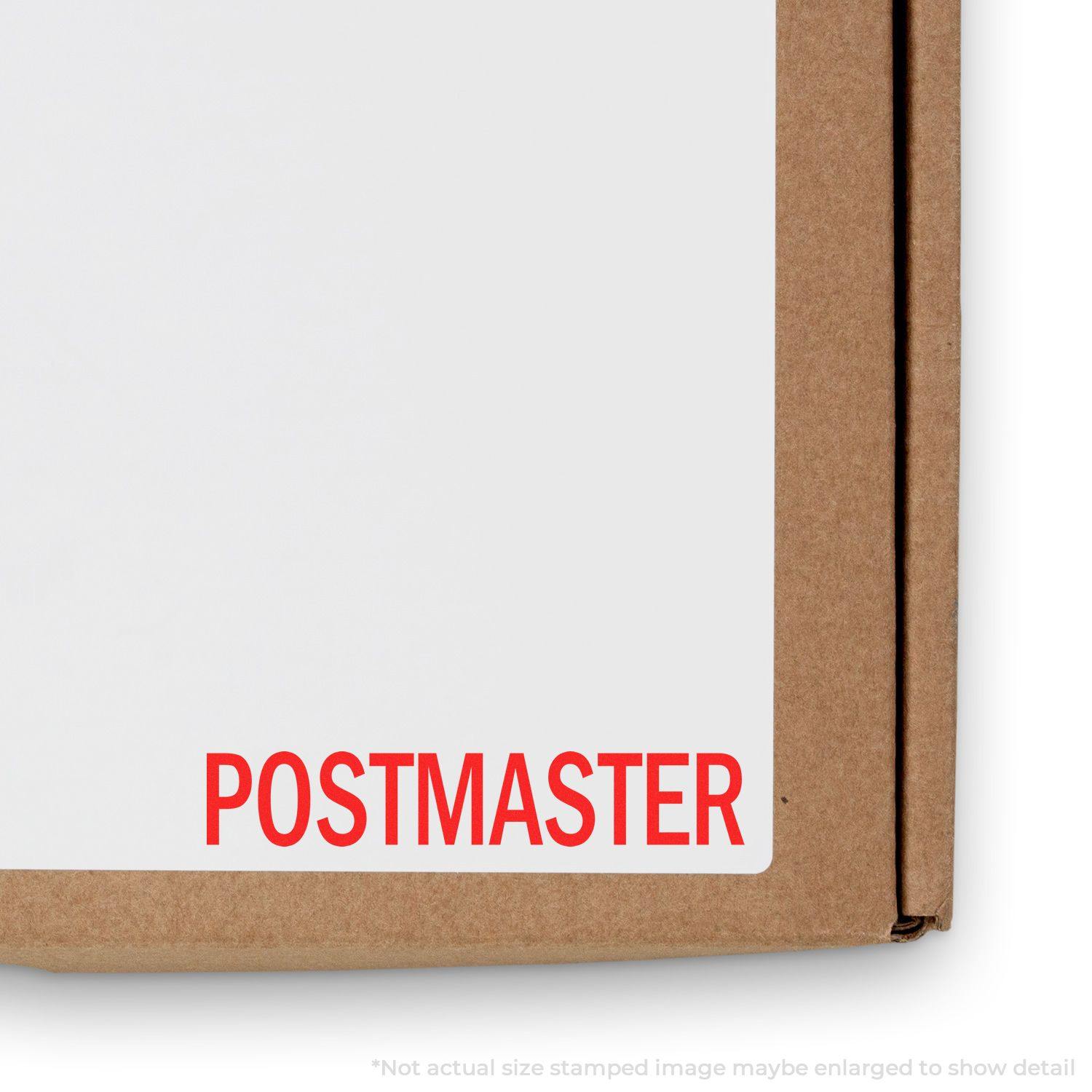 Large Pre-Inked Postmaster Stamp in red ink used on a white label attached to a brown cardboard box.