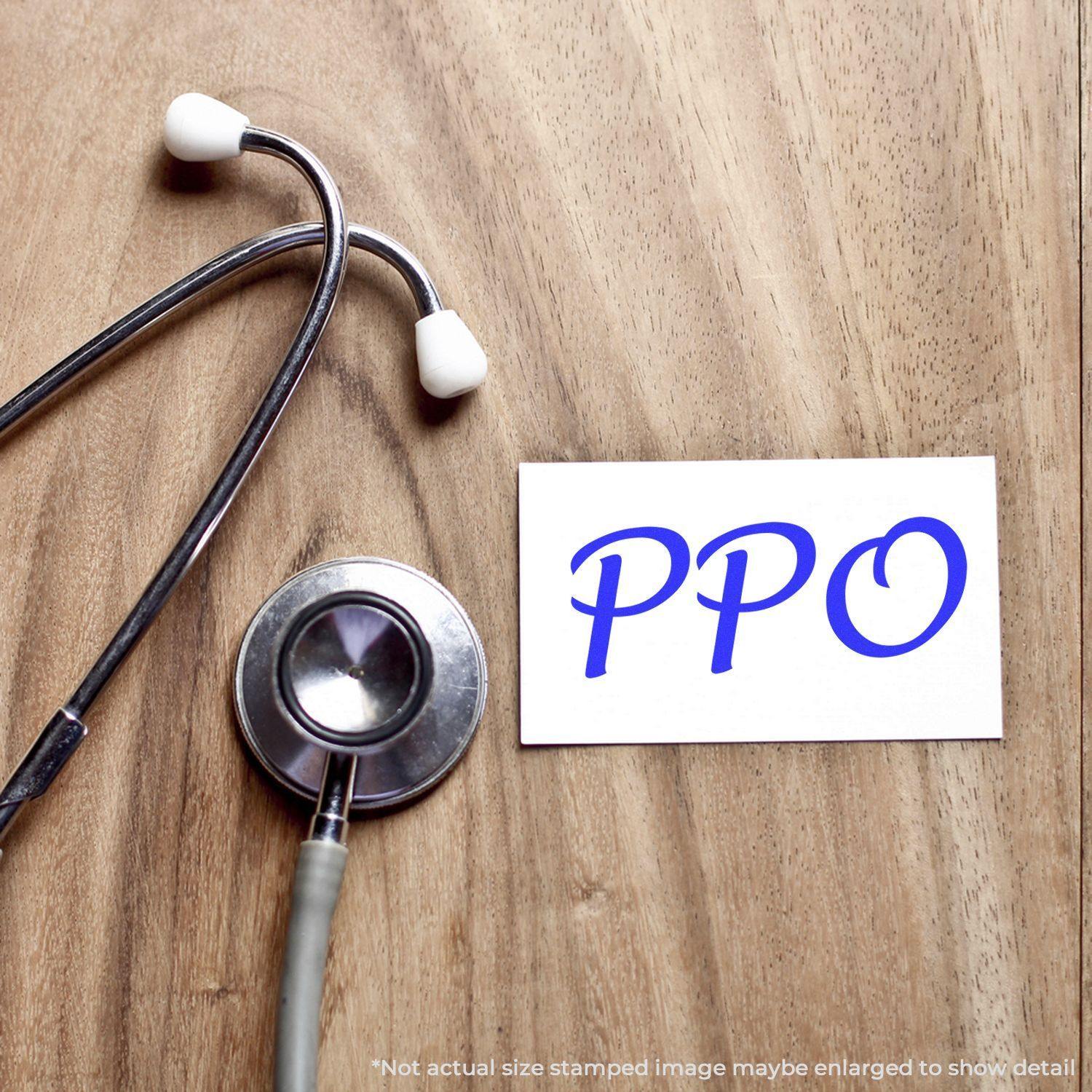 Stethoscope on wooden surface next to a card stamped with PPO in blue, using a PPO Rubber Stamp.