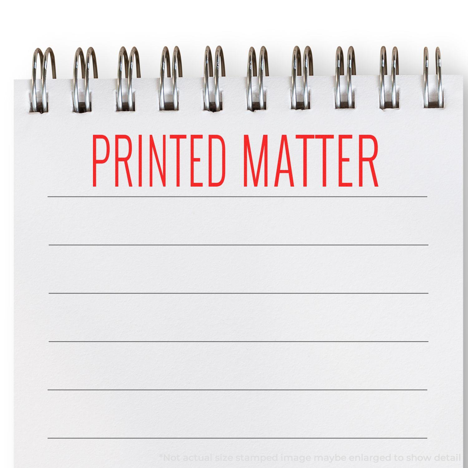 Large Pre-Inked Printed Matter Stamp in red ink on a spiral notebook page with lined paper.