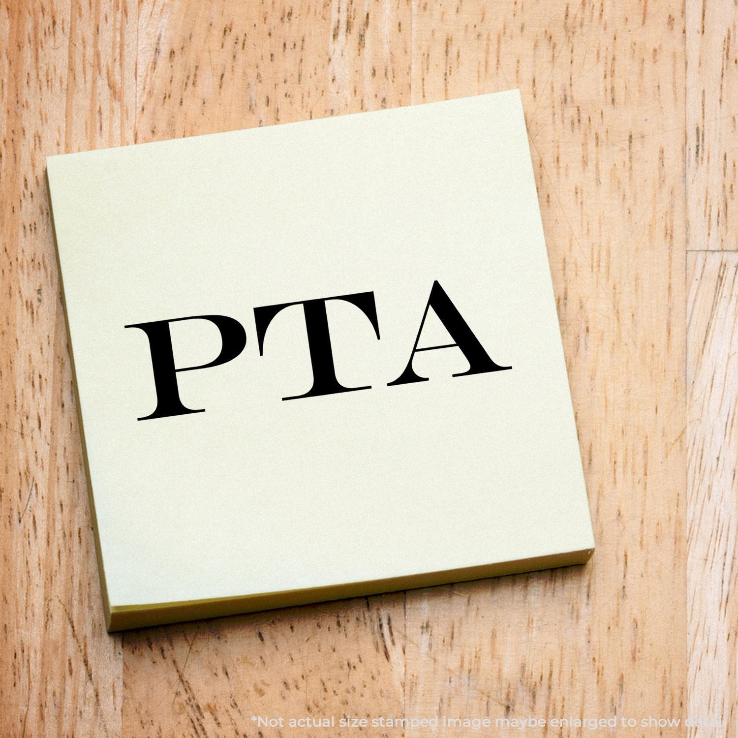 A self-inking stamp with a stamped image showing how the text "PTA" is displayed after stamping.