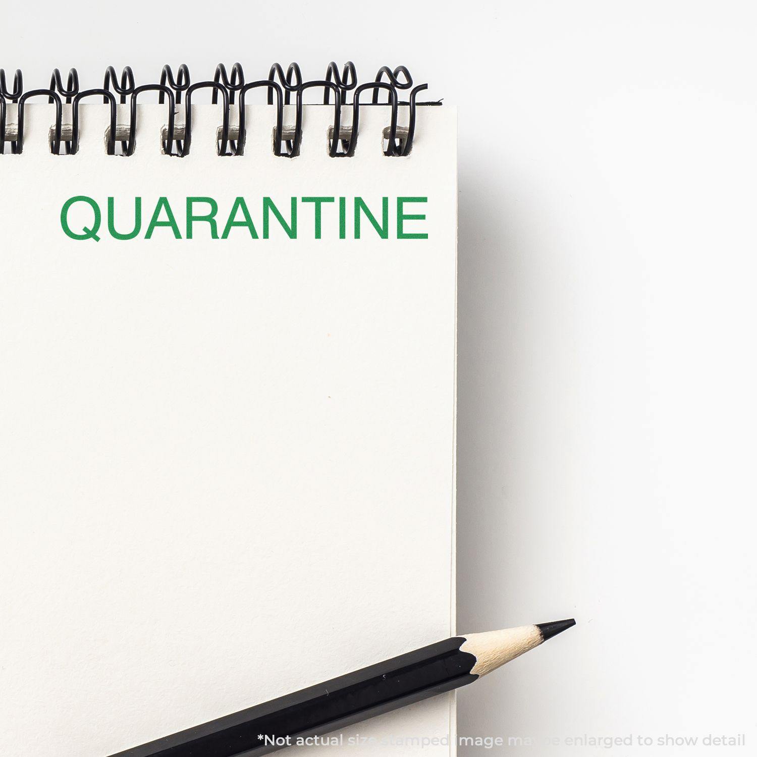 Large Pre-Inked Quarantine Stamp in green ink on a white notepad, with a black pencil placed beside the notepad.