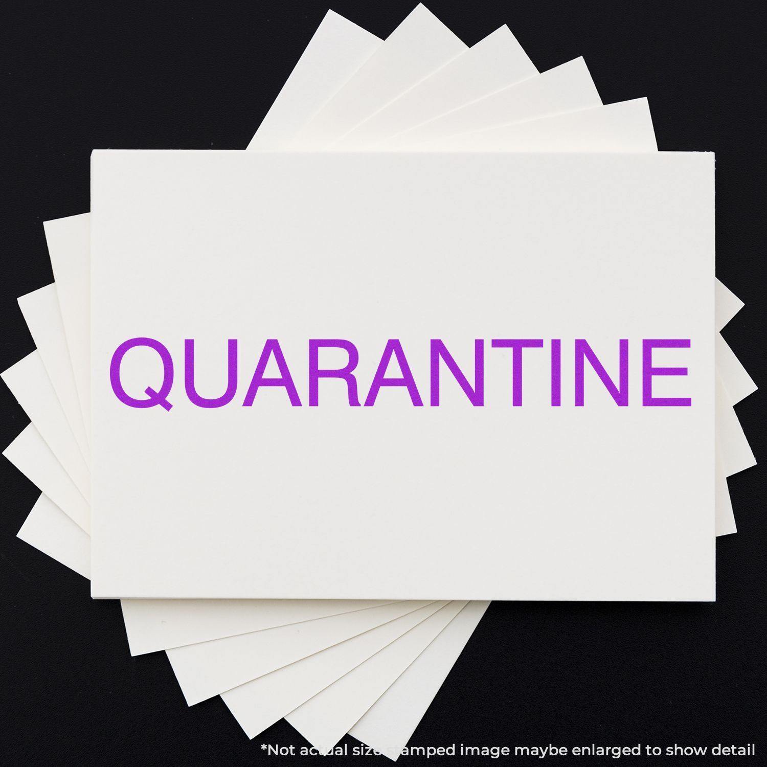 Slim Pre-Inked Quarantine Stamp in purple ink on a white card, with multiple cards fanned out underneath on a black background.