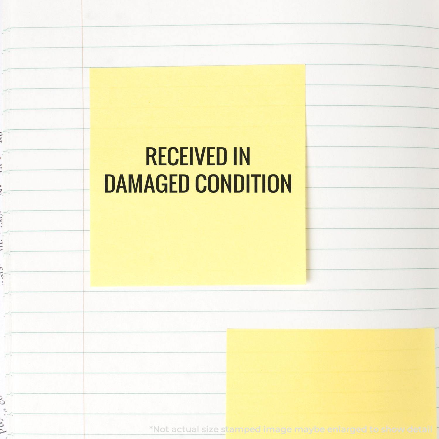 Large Received in Damaged Condition Rubber Stamp used on a yellow sticky note placed on a lined notebook page.