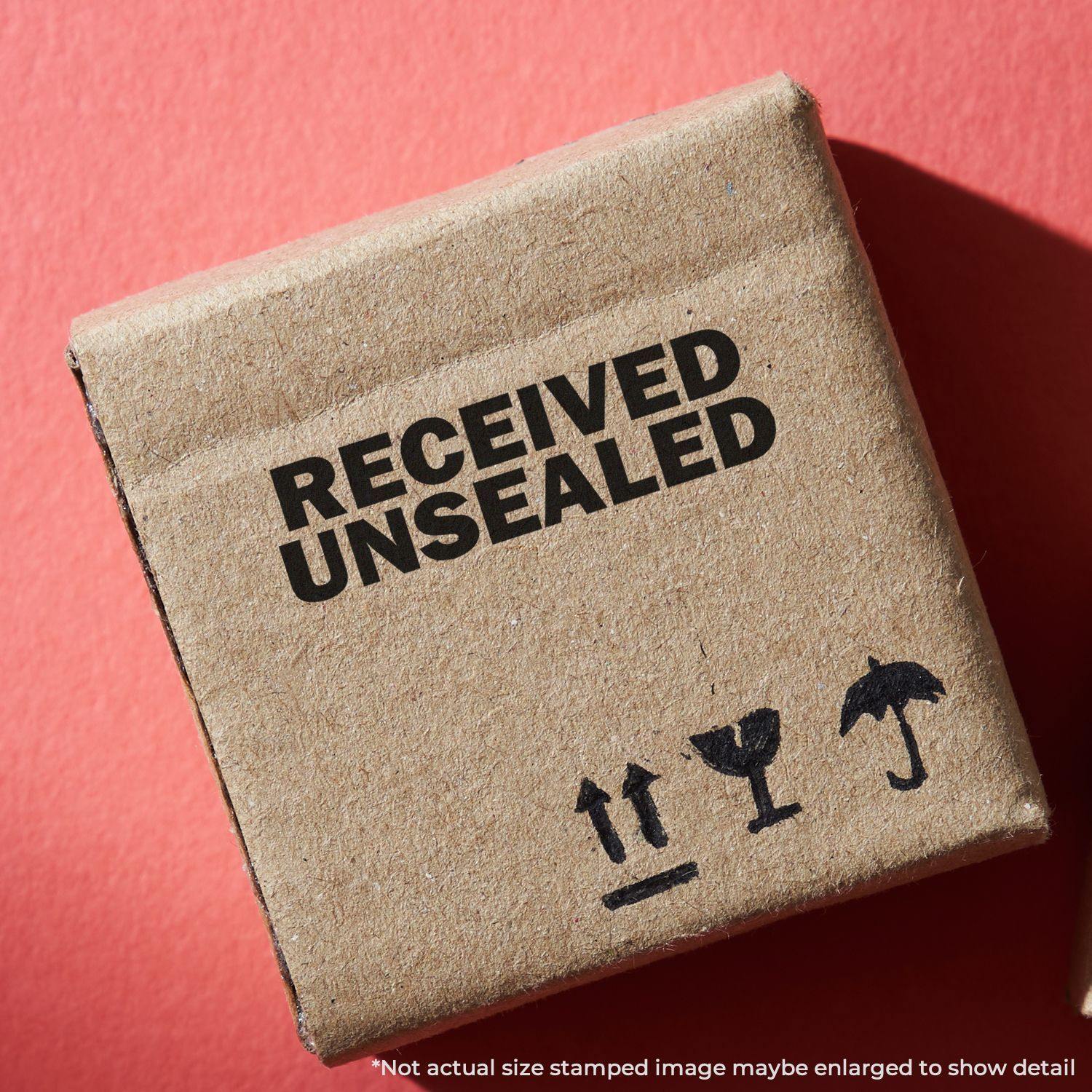 Cardboard box stamped with RECEIVED UNSEALED using the Large Pre-Inked Received Unsealed Stamp on a red background.