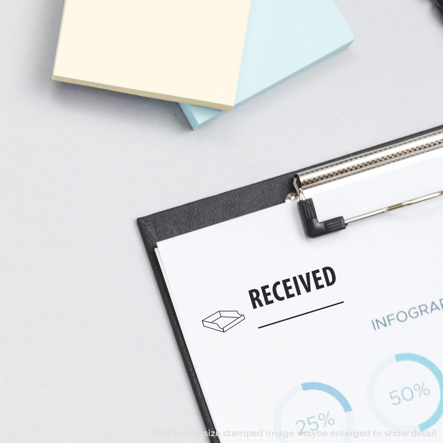 Large Self Inking Received with Box Stamp marking a document on a clipboard, with sticky notes in the background.