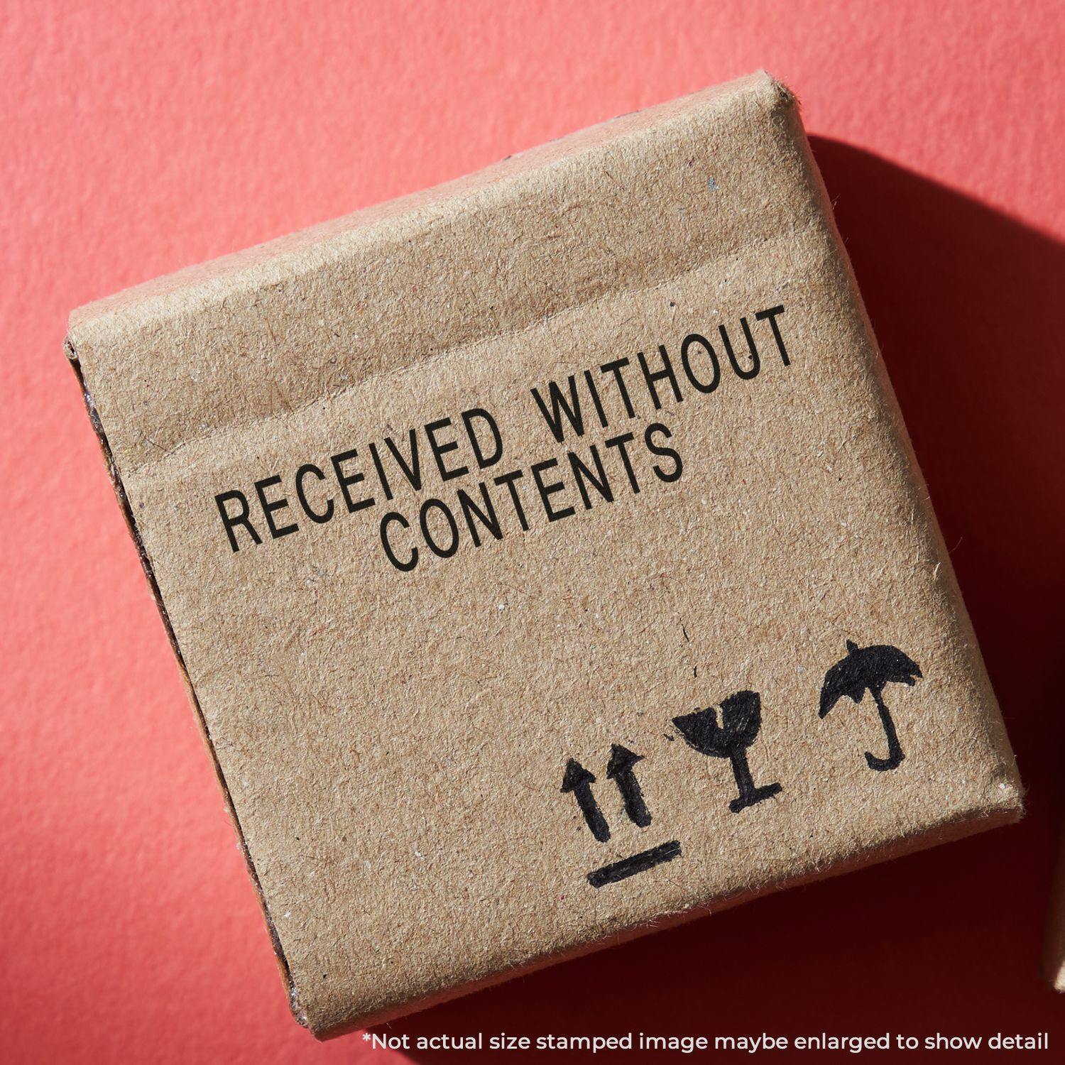 A cardboard box stamped with RECEIVED WITHOUT CONTENTS using the Large Pre-Inked Received Without Contents Stamp on a red background.