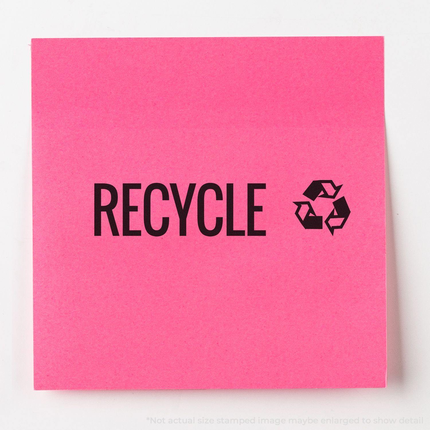 Large Pre-Inked Recycle with Logo Stamp used on a pink sticky note, displaying the word RECYCLE and a recycling symbol.