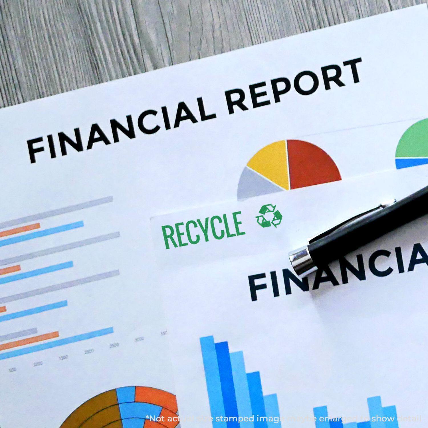 Large Pre-Inked Recycle with Logo Stamp used on financial reports, showing a green recycle symbol and the word RECYCLE stamped on paper.