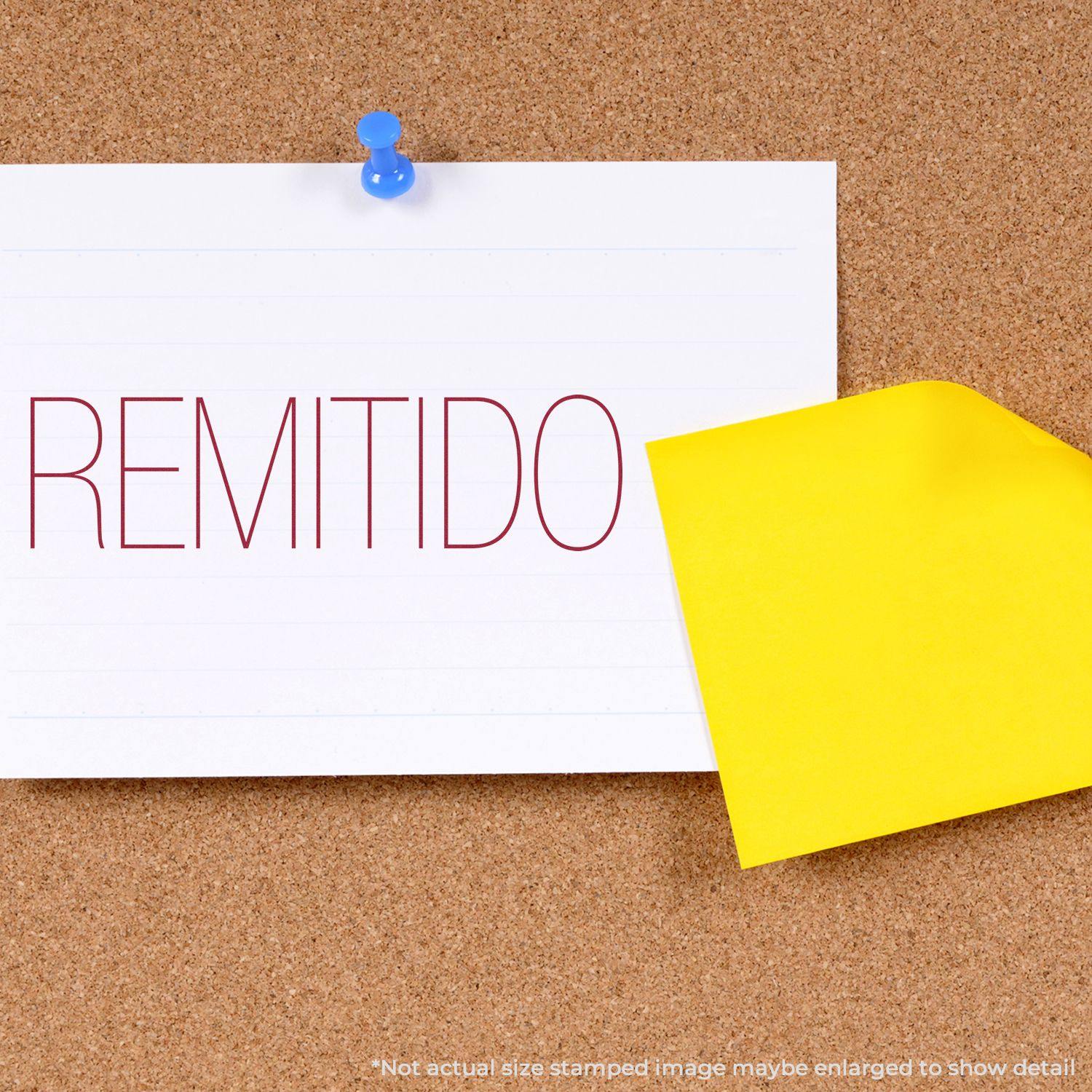 Large Pre-Inked Remitido Stamp used on a white card pinned to a corkboard, with a yellow sticky note beside it.