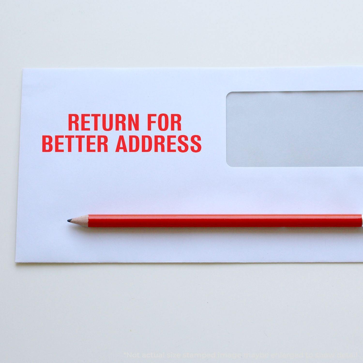 Envelope with Return for Better Address rubber stamp in red ink, accompanied by a red pencil on a white background.