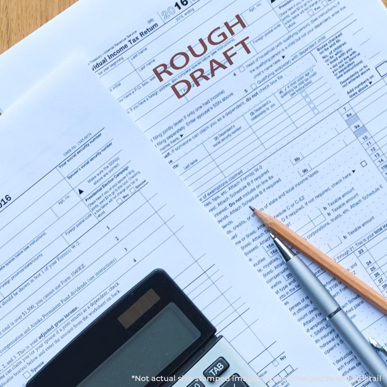 Tax forms stamped with Rough Draft in red ink, accompanied by a calculator and pencil on a wooden surface.