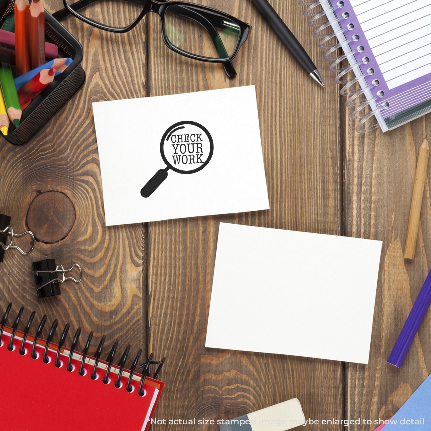 Desk with stationery and a stamped paper reading Check Your Work using the Self Inking Round Check Your Work Stamp.