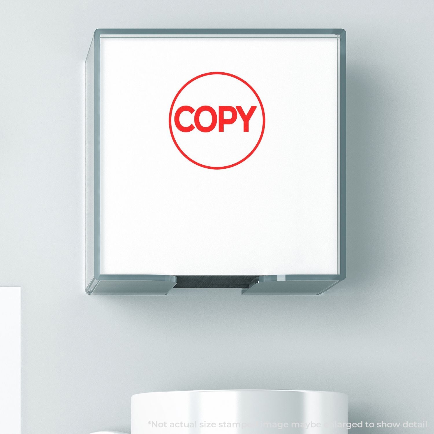 Self Inking Round Copy Stamp with red COPY text on a white background, shown in use on a light grey surface.