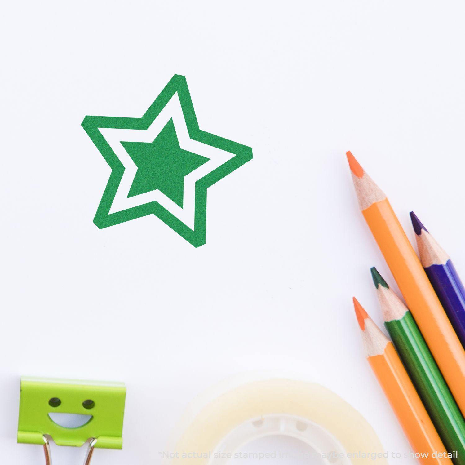 Round Double Star Rubber Stamp in green ink on white paper, surrounded by colored pencils, tape, and a smiling binder clip.