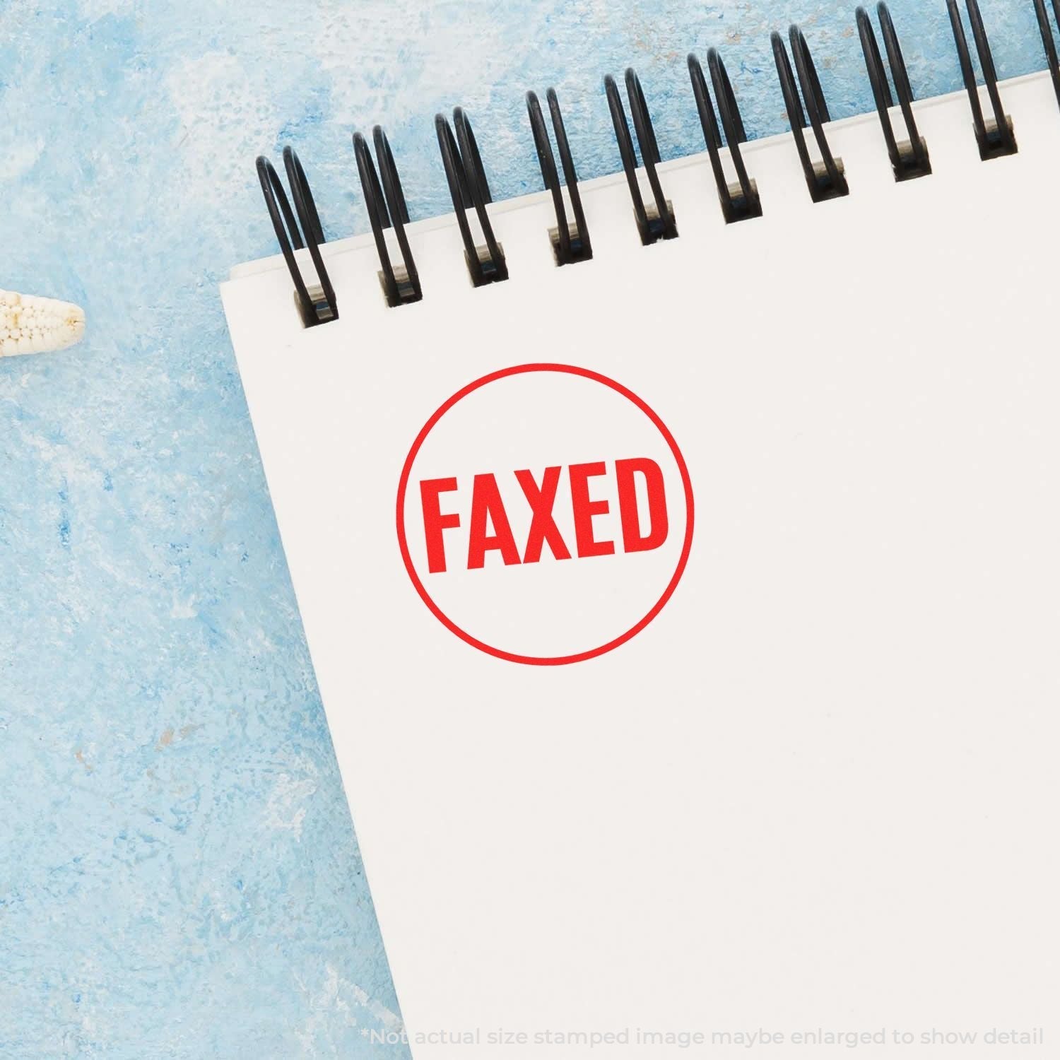 Self Inking Round Faxed Stamp imprint in red on a white notepad with a blue background.