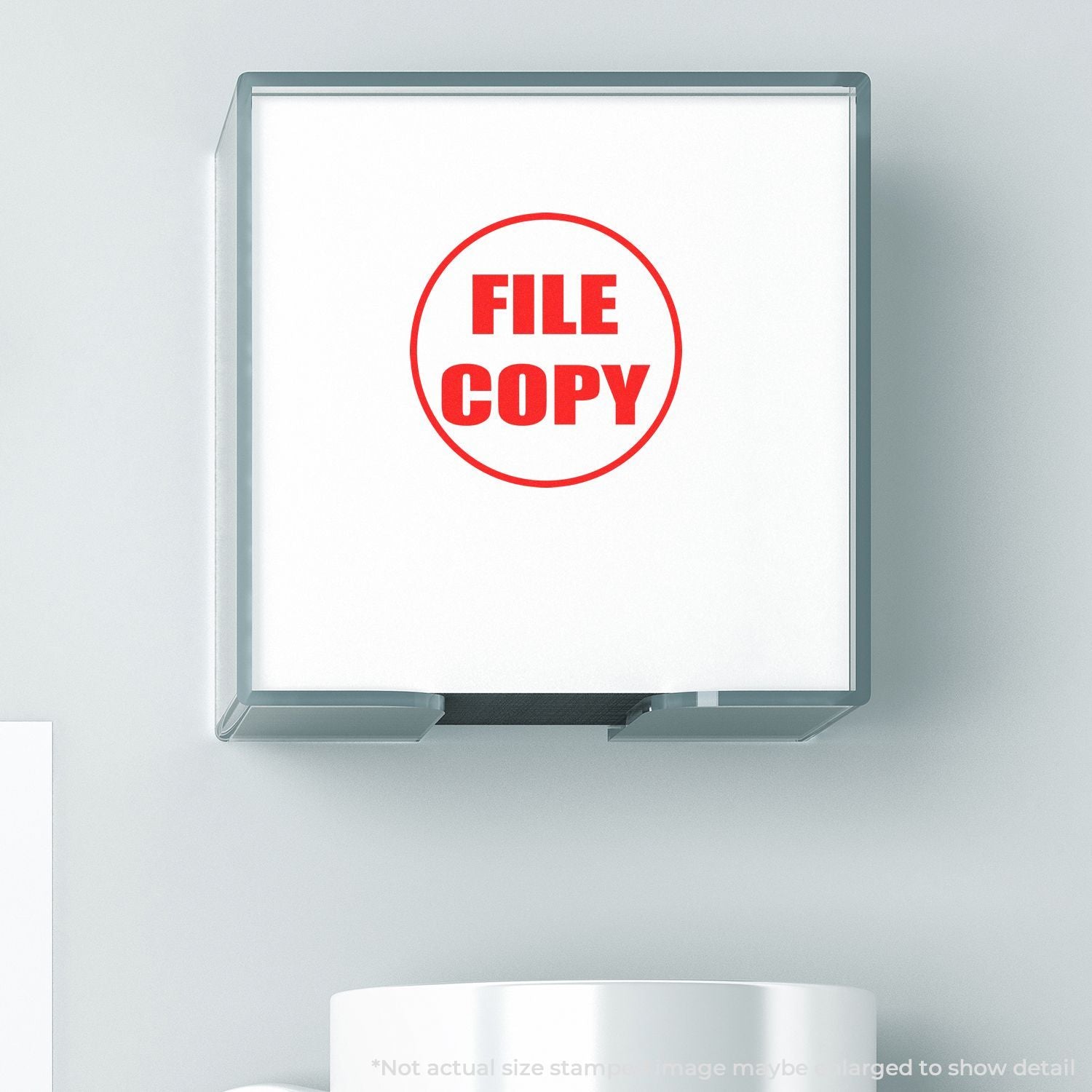 Self Inking Round File Copy Stamp with red FILE COPY text, mounted on a wall, with a white background and a partial view of a white mug.