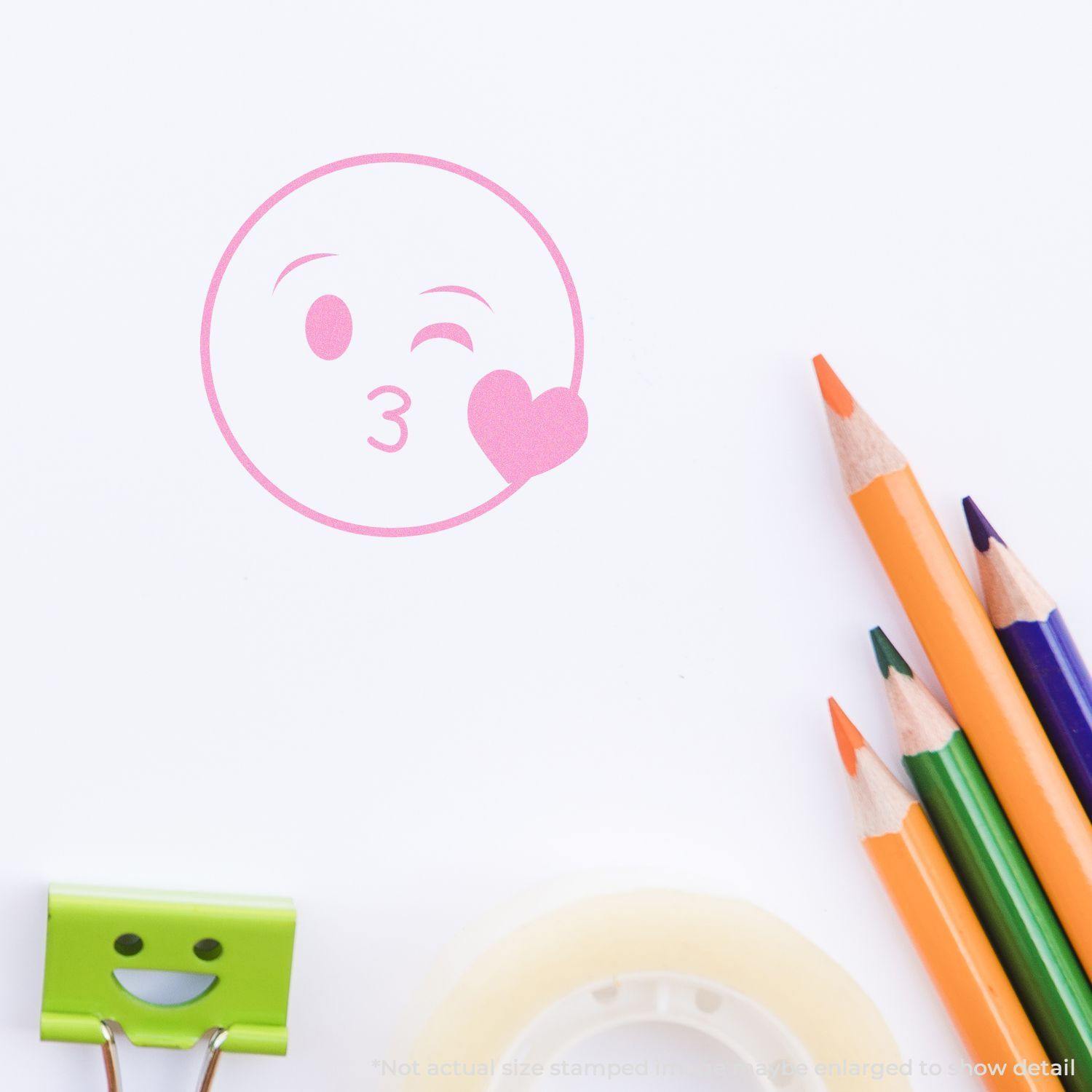 Round Happy Smiley Rubber Stamp in pink ink on white paper, with colored pencils, a smiley clip, and tape nearby.