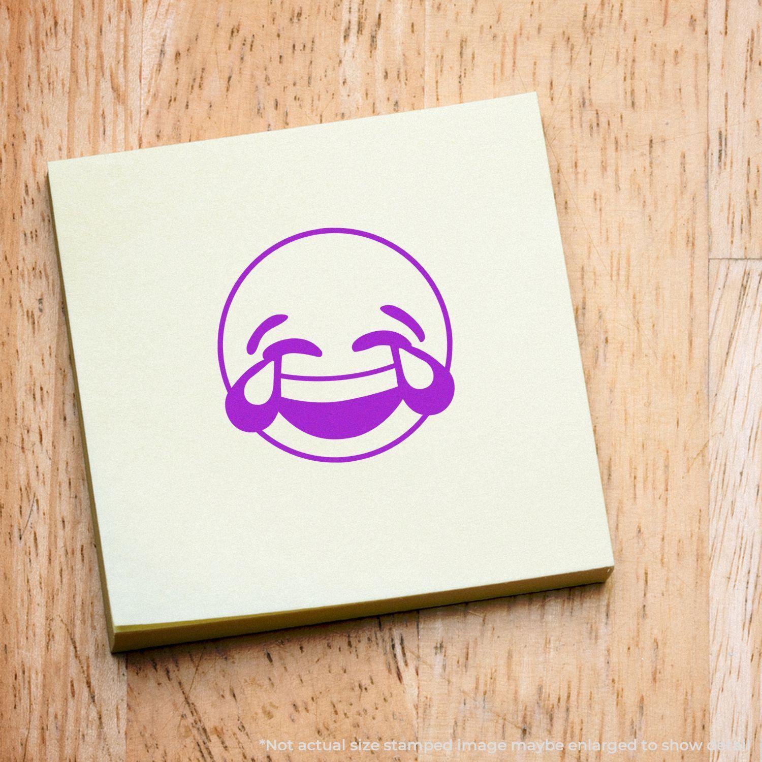 Round Laughing Smiley Rubber Stamp impression on a yellow sticky note, showing a laughing emoji with tears of joy.