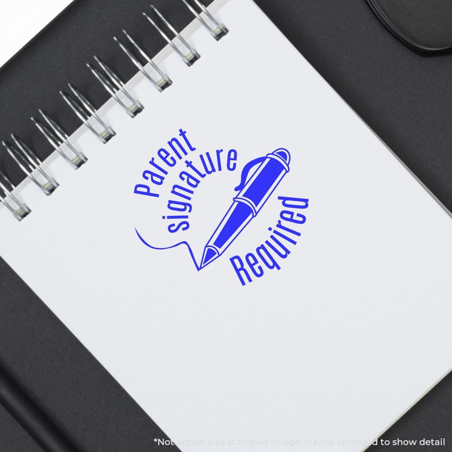 Self Inking Round Parent Signature Required Stamp in blue ink on a white notebook, showing a pen icon and the text Parent Signature Required.