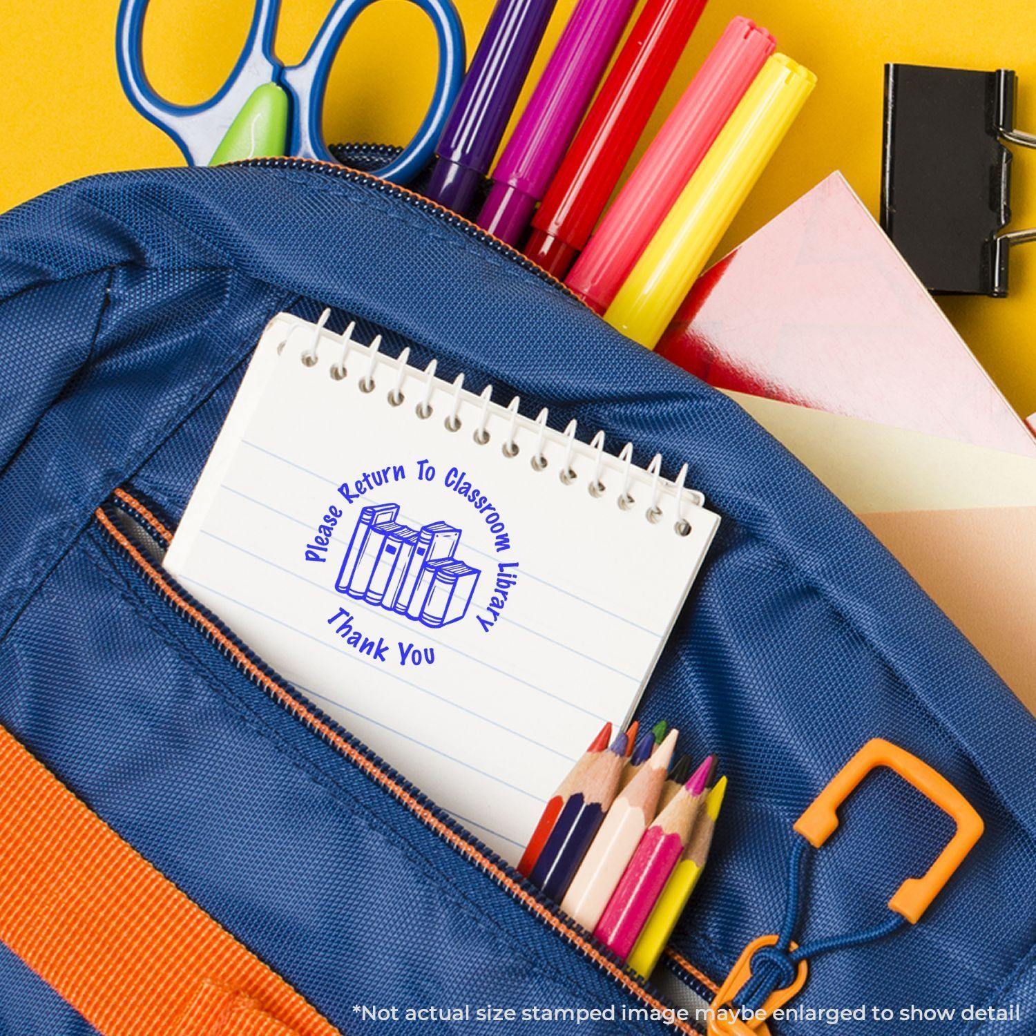 A blue backpack with school supplies and a notebook stamped with a round Please Return to Classroom rubber stamp.