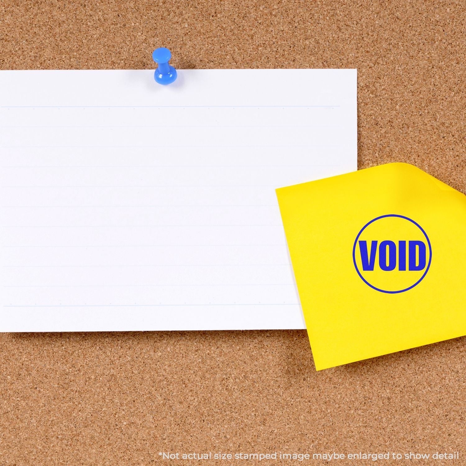 Self Inking Round Void Stamp used on a yellow sticky note pinned to a corkboard, next to a blank white paper.