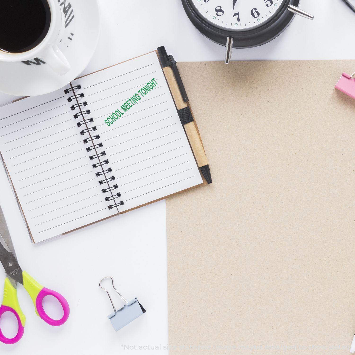 Desk with a notebook stamped 'School Meeting Tonight,' scissors, coffee cup, clock, and binder clip.