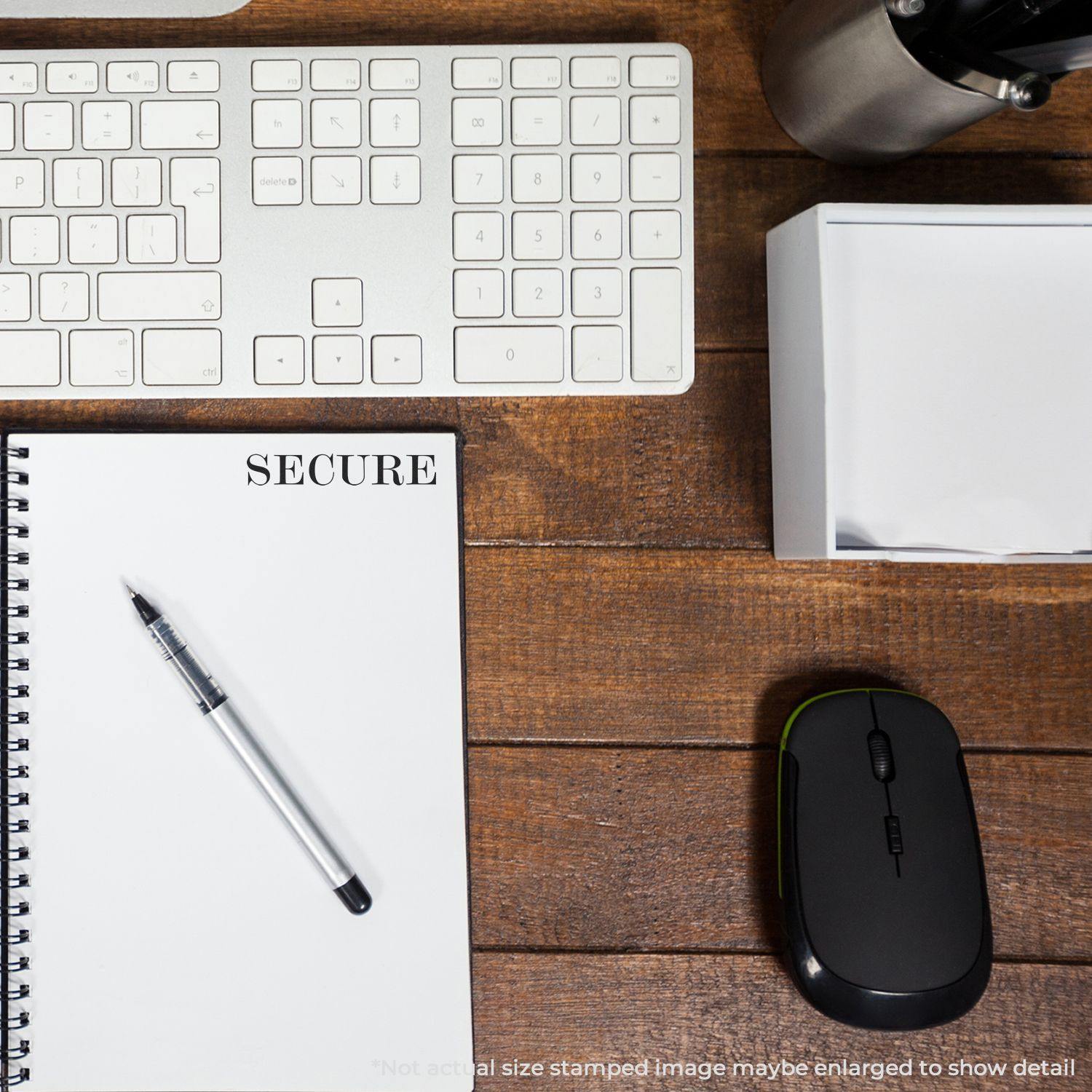 Large Pre-Inked Secure Stamp used on a notebook labeled SECURE on a wooden desk with a keyboard, mouse, pen, and office supplies.