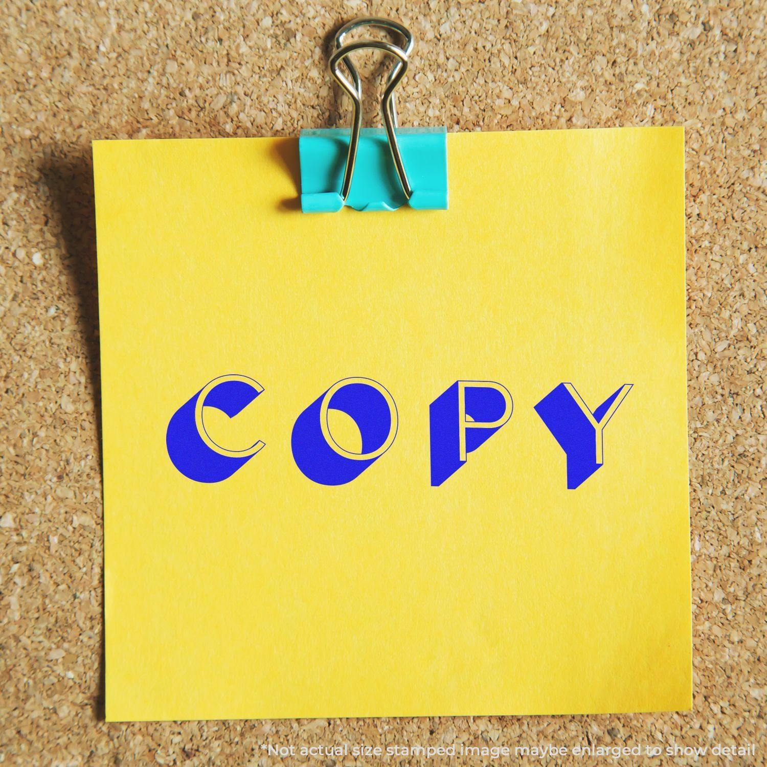 Yellow sticky note with COPY stamped in blue using the Large Self Inking Shadow Copy Stamp, pinned to a corkboard with a blue binder clip.