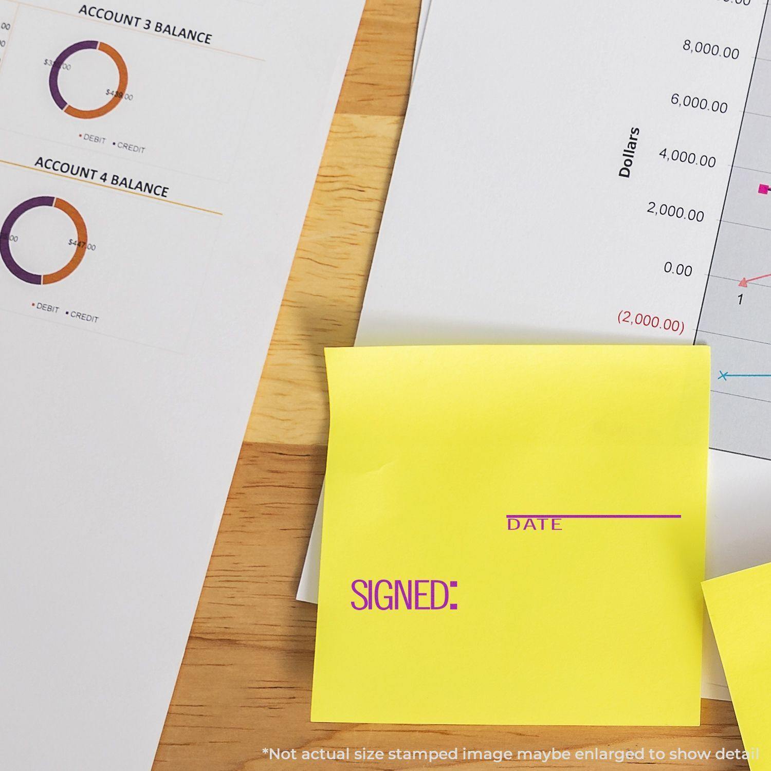 Large Self Inking Signed with Date Stamp used on a yellow sticky note, placed on a desk with financial documents.