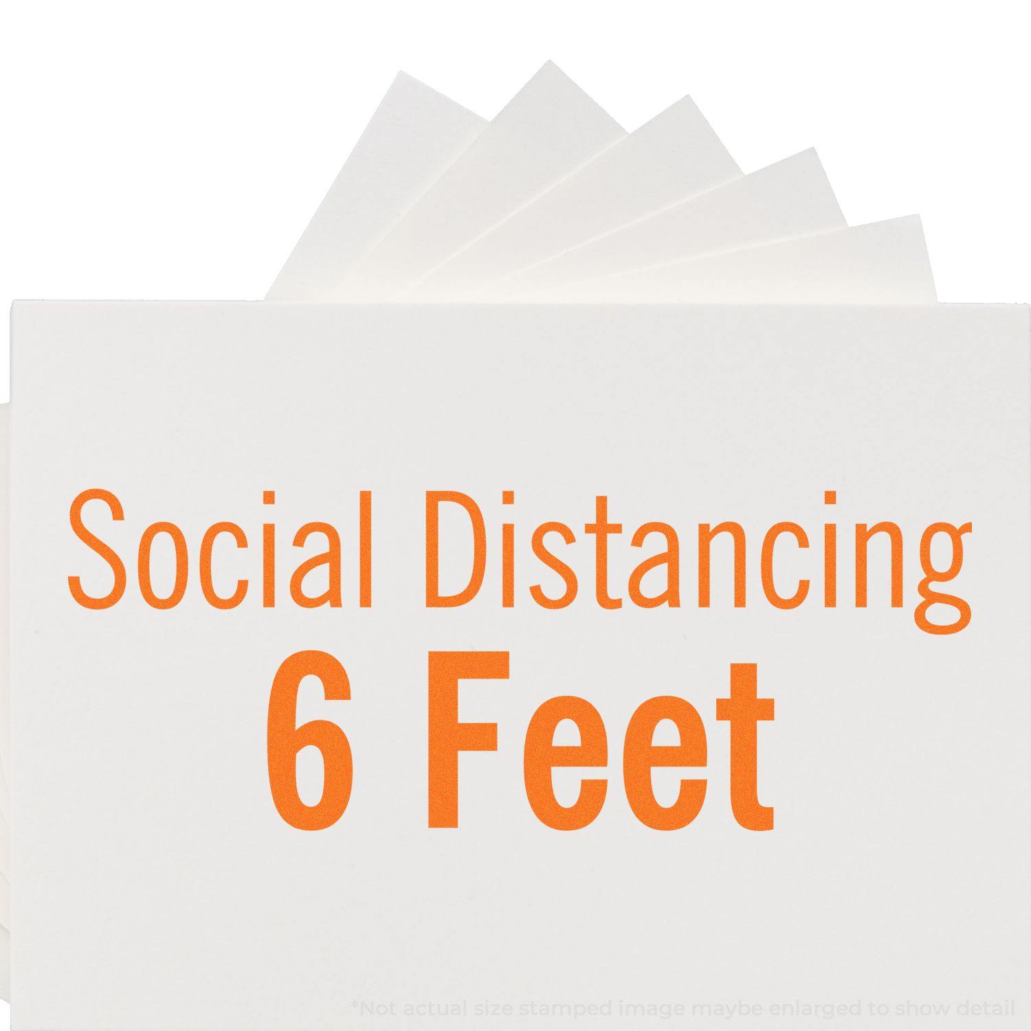 Large Pre-Inked Social Distancing 6 Feet Stamp in use, showing the bold orange text Social Distancing 6 Feet on a white background.