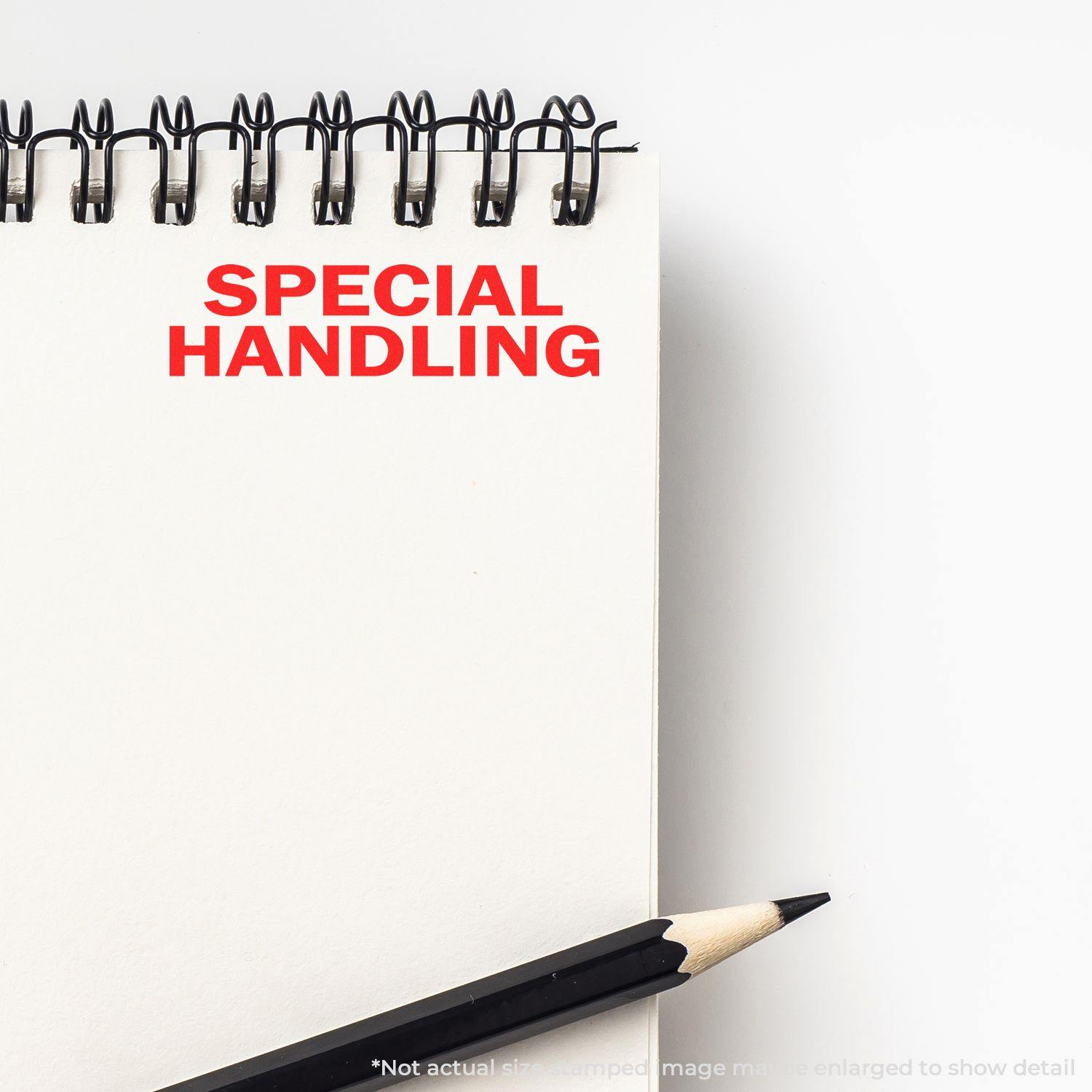 Large Self Inking Special Handling Stamp imprinting SPECIAL HANDLING in red on a white notepad, with a pencil nearby.